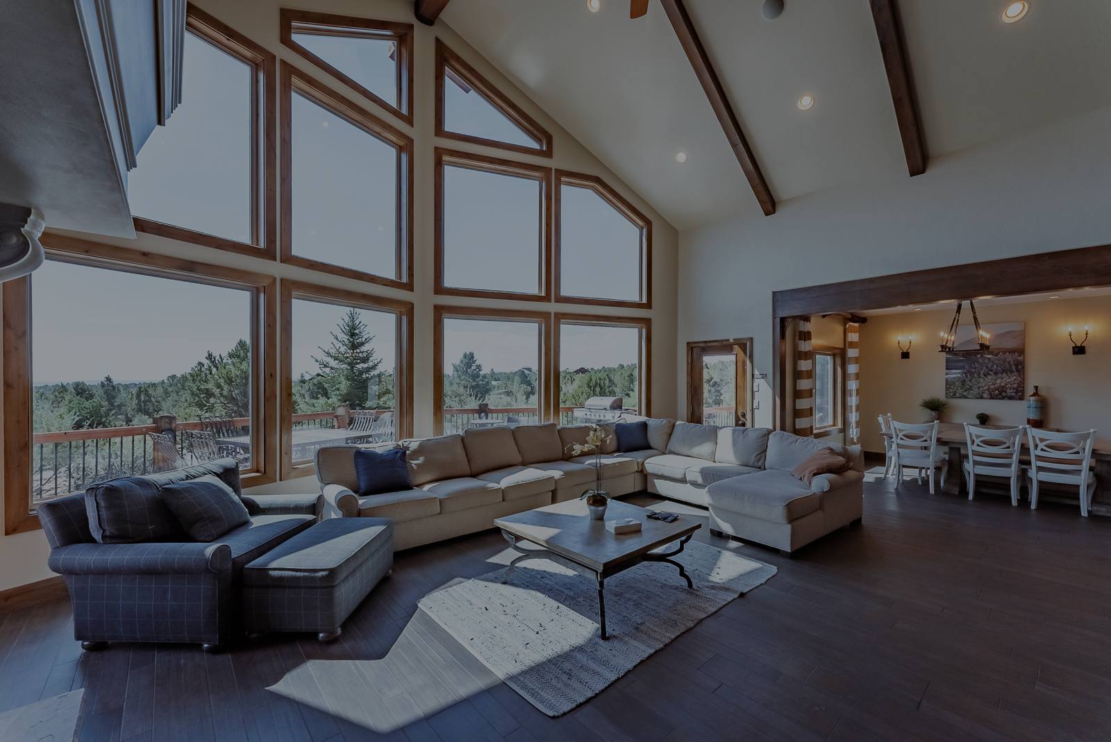 A modern vacation home at dusk with its lights on